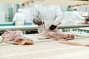 Picture of people processing meats